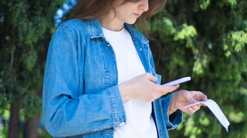 Woman who scans a receipt with TriFact365 accounting software.