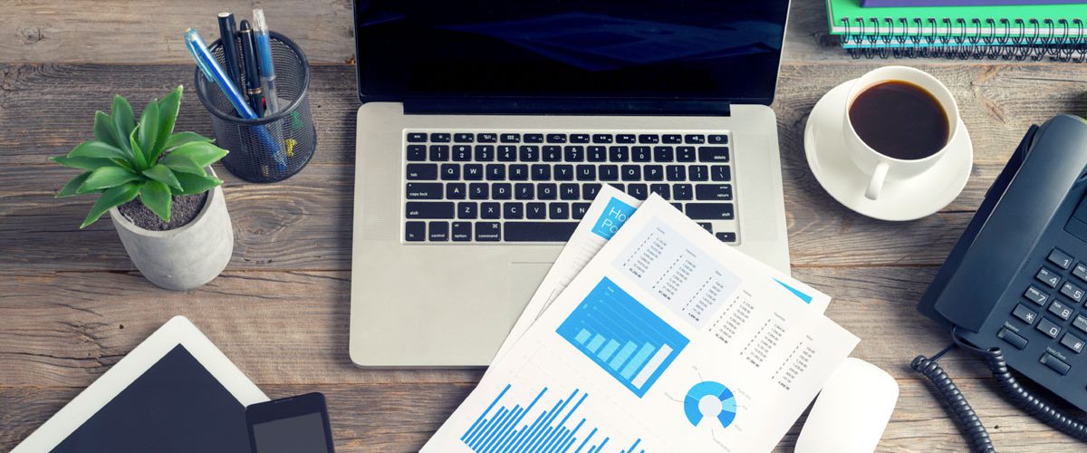 laptop with invoices and a cup of coffee to portray the convenience of TriFact365 in support of the 10 tips for receiving digital invoices.